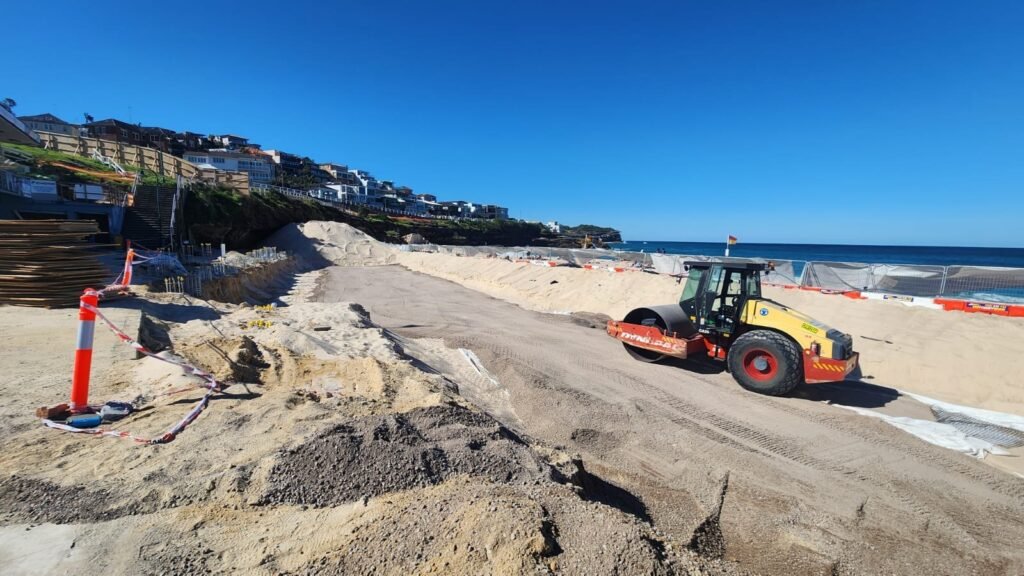 Compaction roller placing and compacting fill at Bronte, NSW
